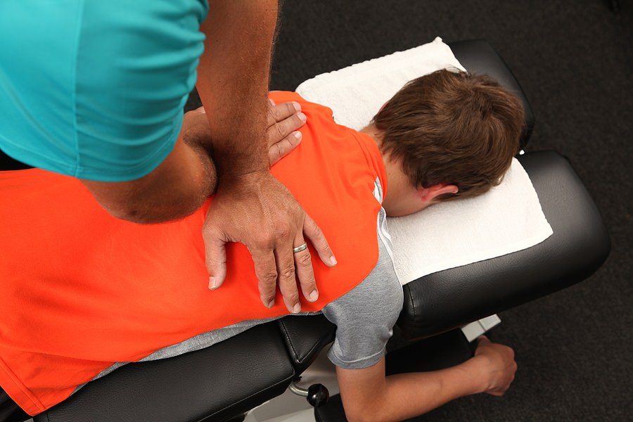 photo of chiropractor adjusting a persons back